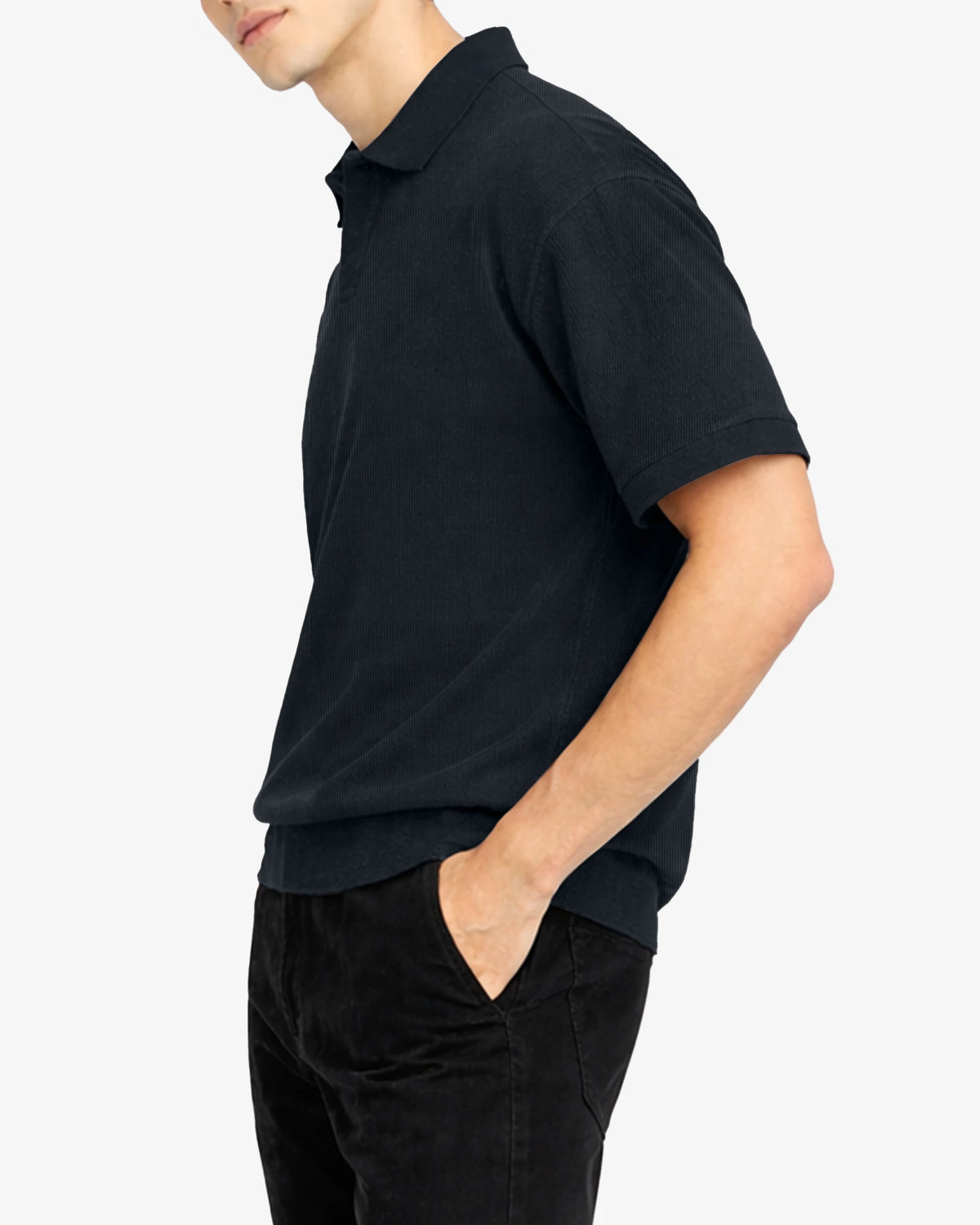 Person wearing a black polo shirt and black pants on a white background