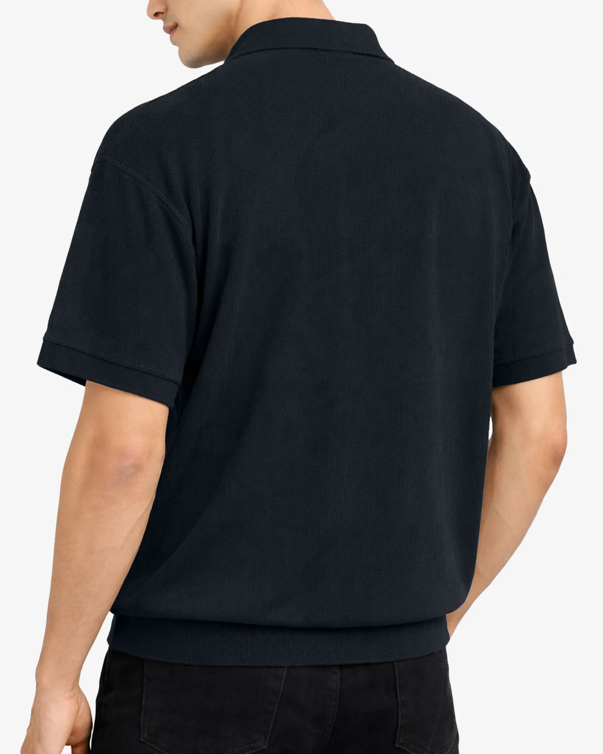 Person wearing a black polo shirt on a white background
