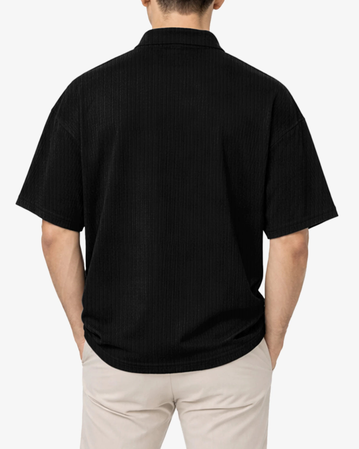 Person wearing a black polo shirt on a white background