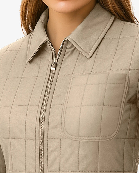 Beige quilted vest with a zipper on a neutral background
