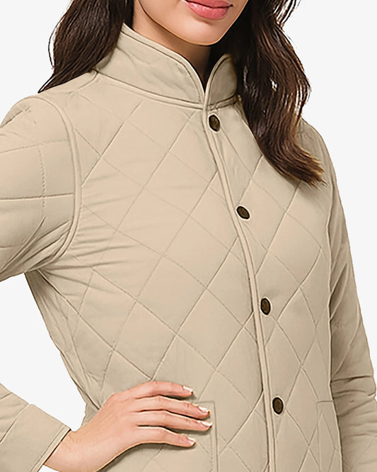 Beige quilted jacket worn by a person on a white background