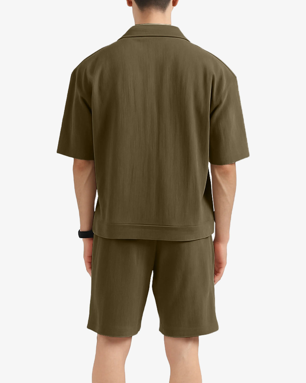 Person wearing a green polo shirt and shorts set on a white background