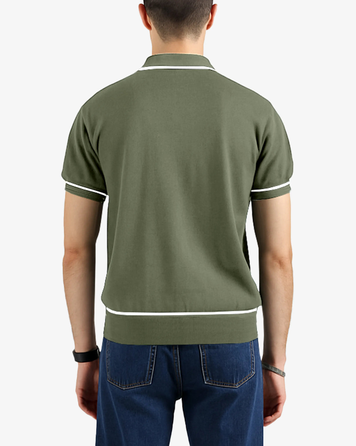 Person wearing a green polo shirt with white trim on a plain background