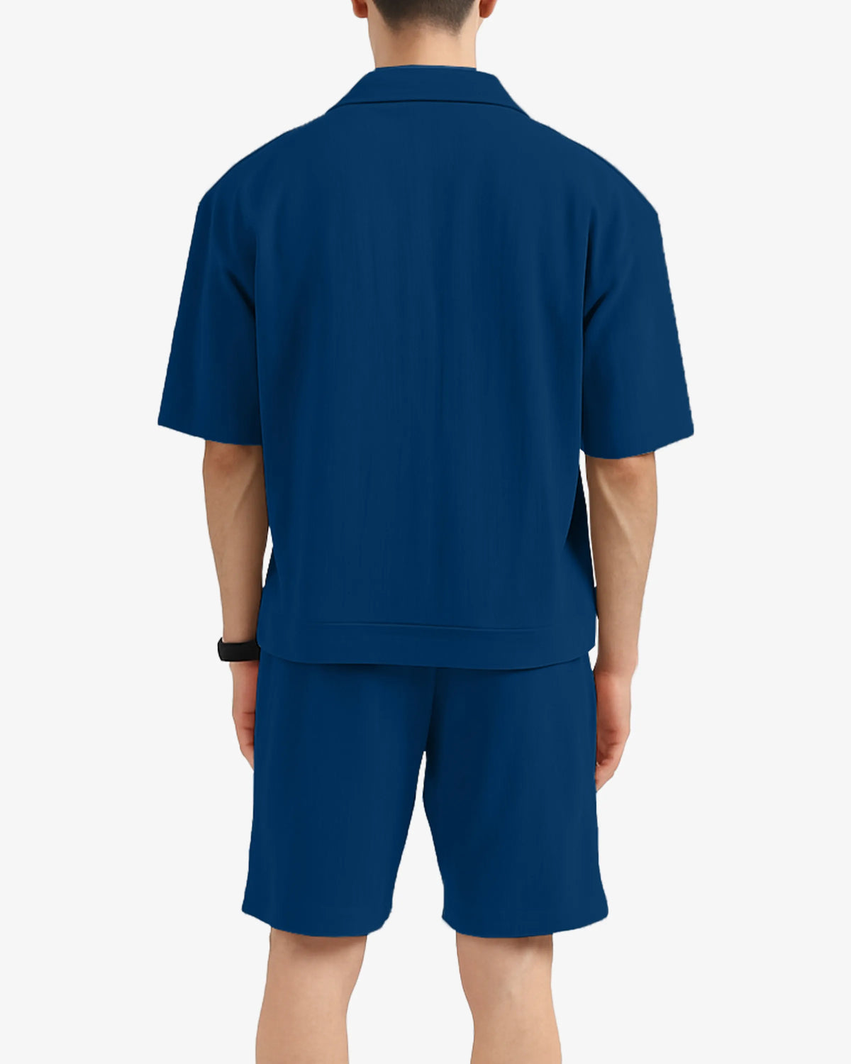 Person wearing a blue polo shirt and shorts set on a white background