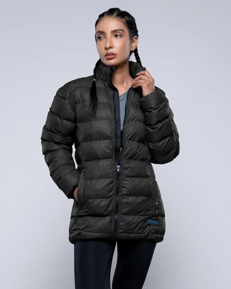Woman wearing a black puffer jacket on a light gray background