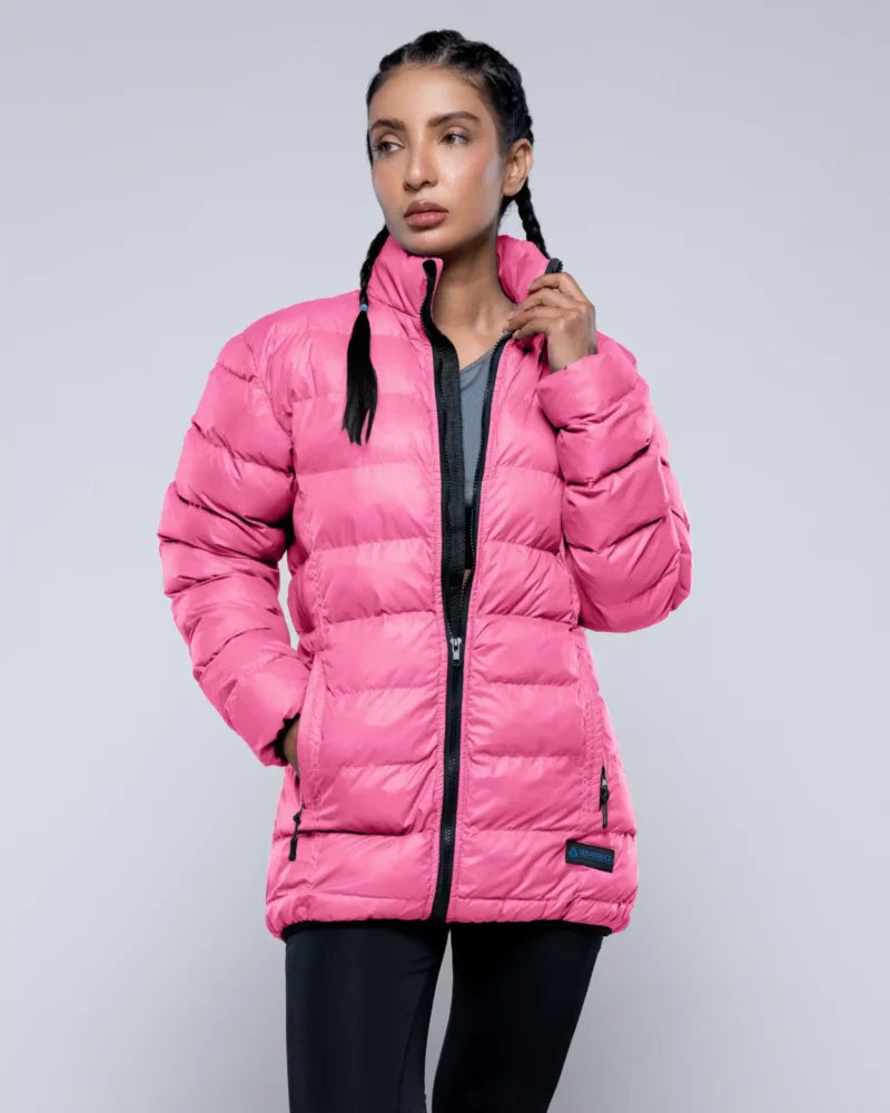 Woman wearing a pink puffer jacket on a gray background
