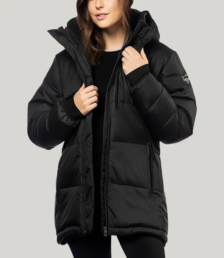 Person wearing a black puffer jacket on a light gray background