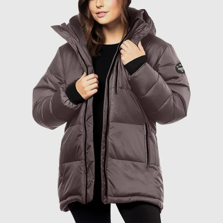 Person wearing a brown puffer jacket on a light gray background