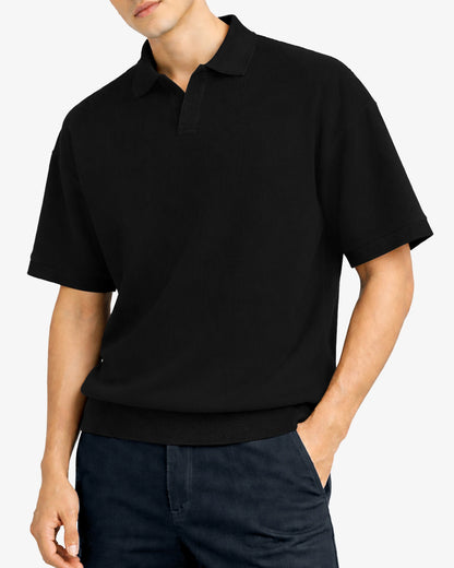 Person wearing a black polo shirt on a white background