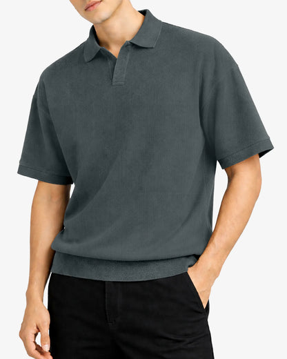 Person wearing a dark gray polo shirt on a white background