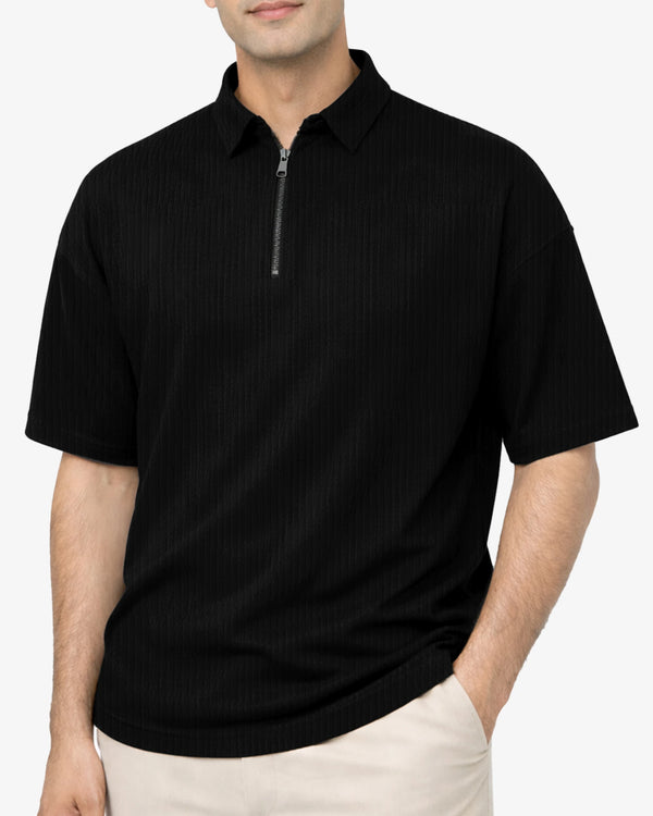 Man wearing a black polo shirt with a zipper on a white background