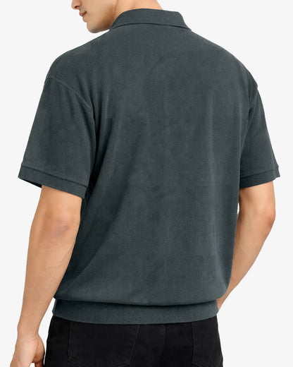 Person wearing a dark gray polo shirt on a white background