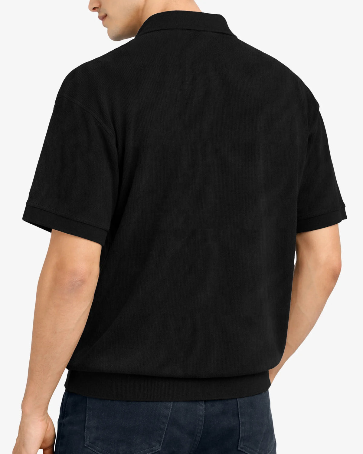 Person wearing a black polo shirt on a white background