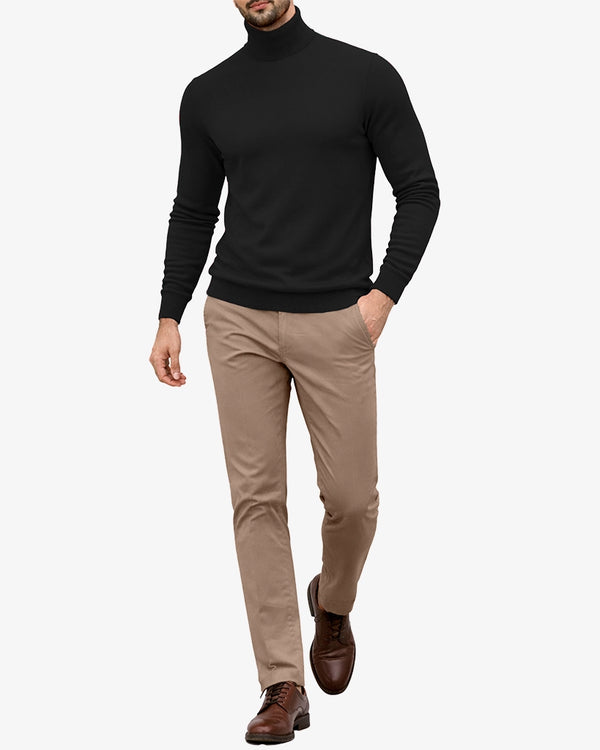 Man wearing a black turtleneck sweater and beige pants on a white background