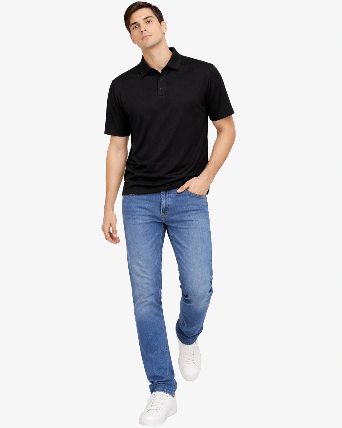 Man wearing a black polo shirt and blue jeans on a white background