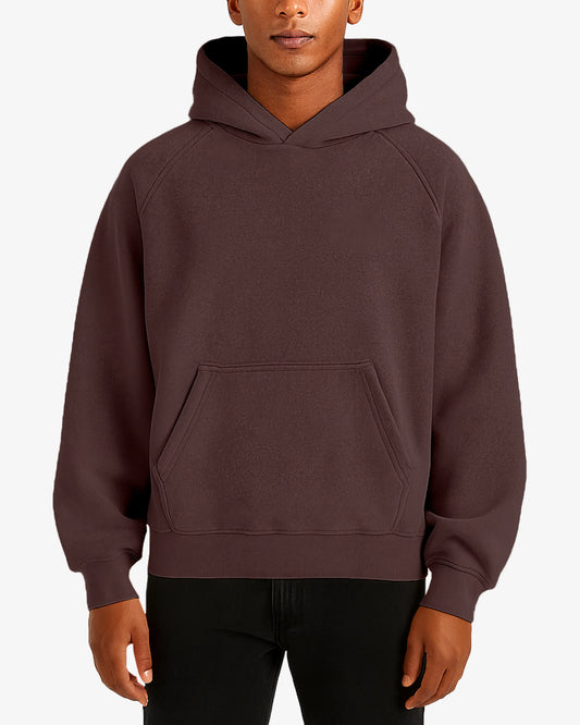 Person wearing a brown hoodie on a white background