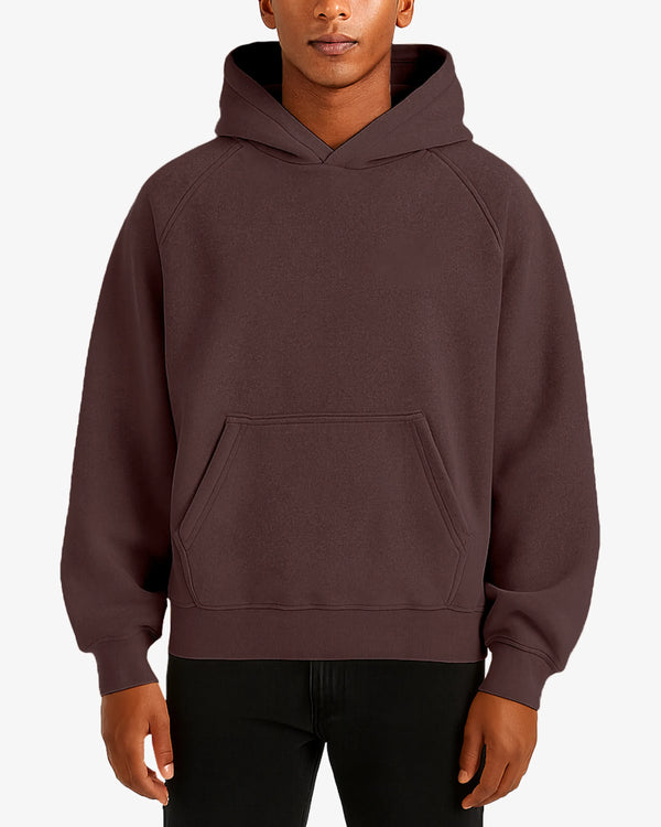 Person wearing a brown hoodie on a white background