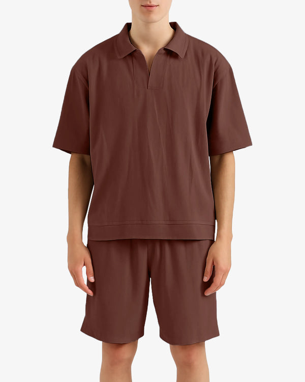 Person wearing a brown polo shirt and shorts set on a white background