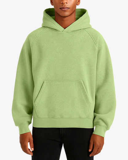 Person wearing a light green hoodie on a white background
