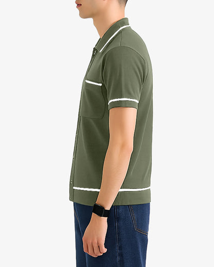 Person wearing a green polo shirt with white accents on a plain background