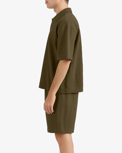 Person wearing a green outfit on a white background