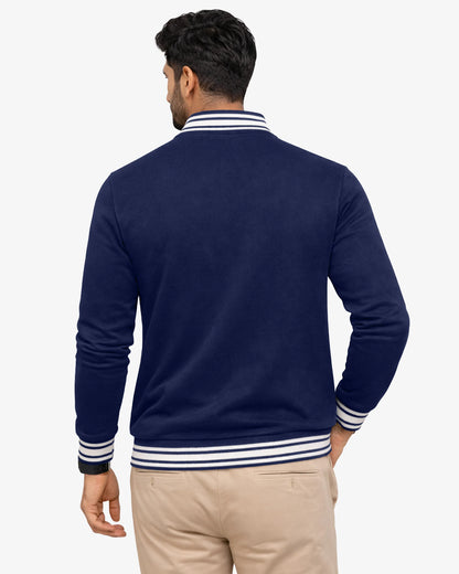 Man wearing a navy blue jacket with white stripes on a white background