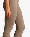 Beige leggings with textured panels on a white background