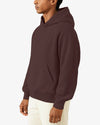 Person wearing a maroon hoodie on a white background