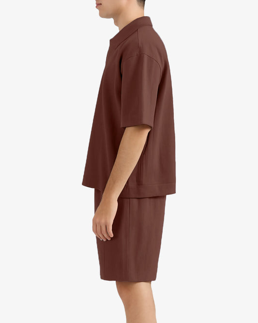 Person wearing a brown outfit on a white background