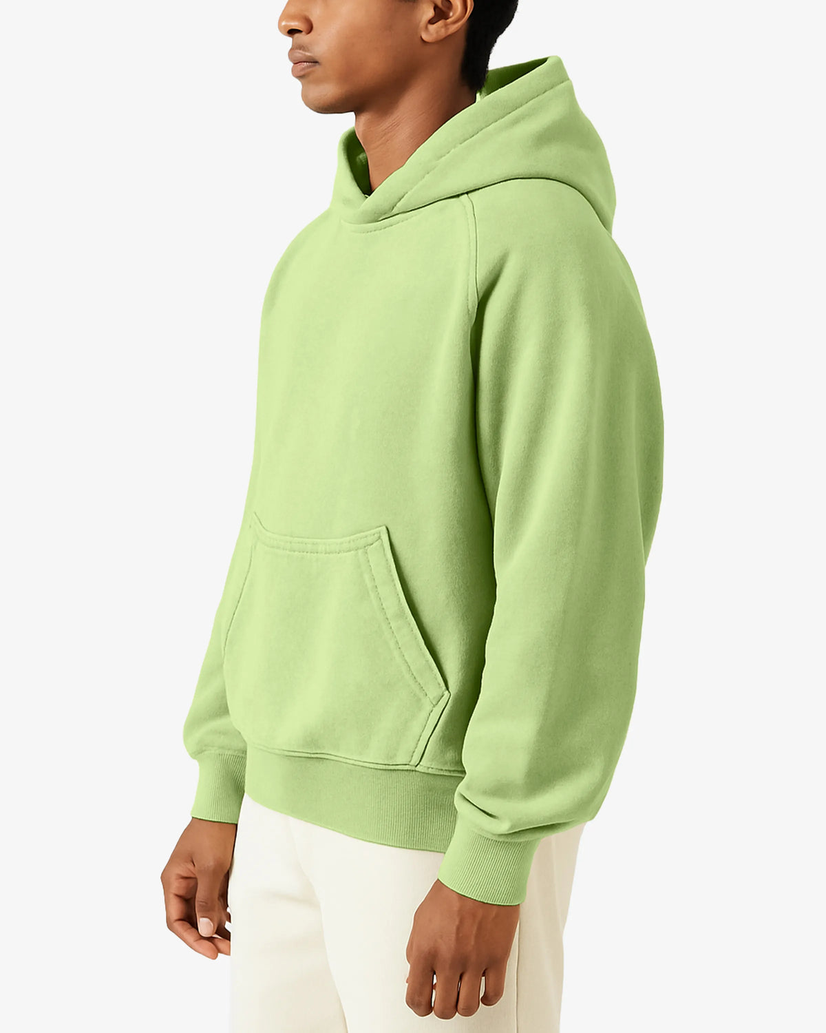 Person wearing a light green hoodie on a white background