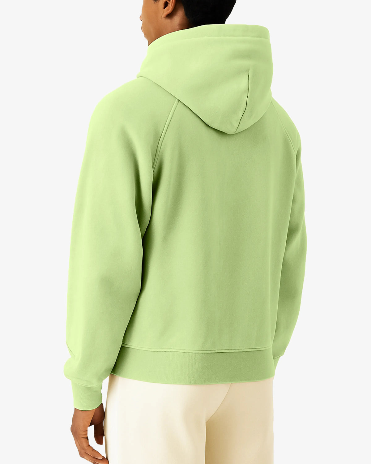 Person wearing a light green hoodie on a white background