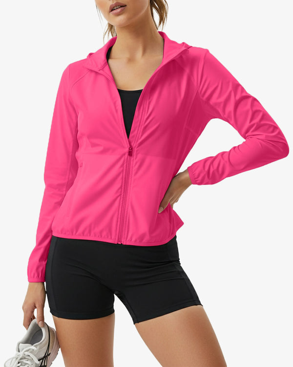 Person wearing a bright pink jacket and black shorts on a white background