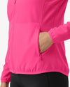 Close-up of a bright pink jacket with a hand in a pocket on a white background