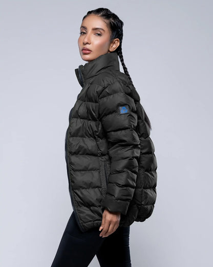 Woman wearing a black puffer jacket on a light gray background