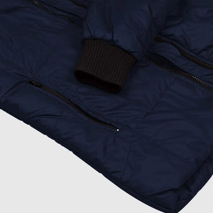 Navy blue puffer jacket with a black knit hat on a light gray background