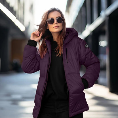 Woman wearing a purple puffer jacket and sunglasses on a city street.