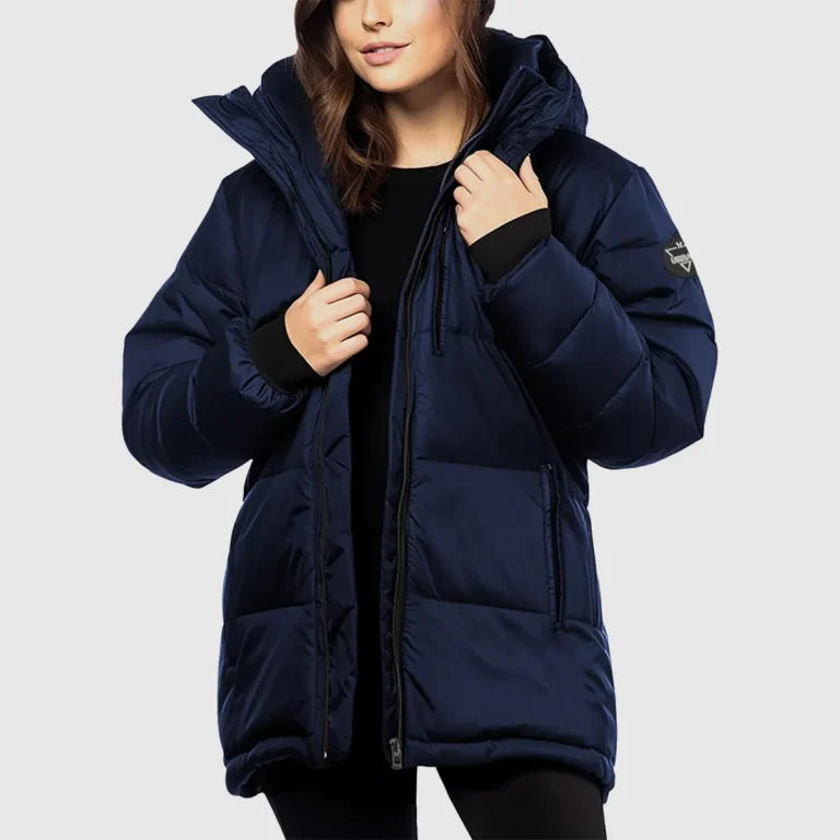 Person wearing a navy blue puffer jacket on a light gray background