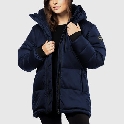 Person wearing a navy blue puffer jacket on a light gray background